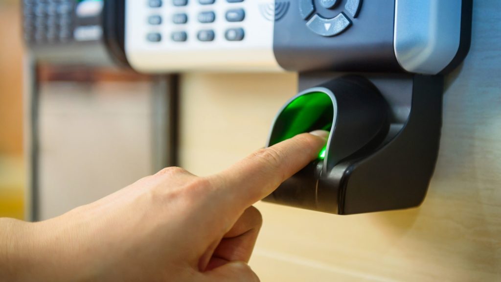 A man presses a button to on an access control system 