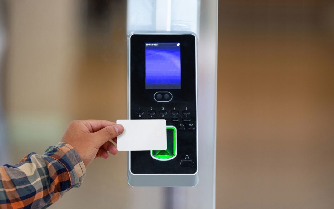 A man scans his key card with an access control system