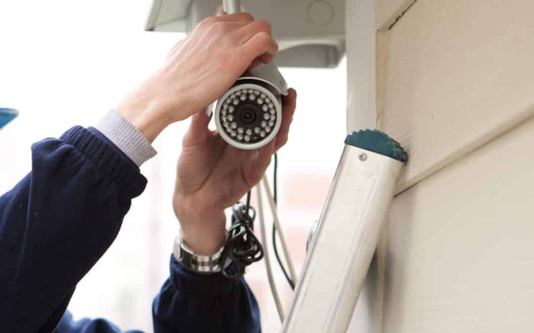 A homeowner installing a DIY home security system